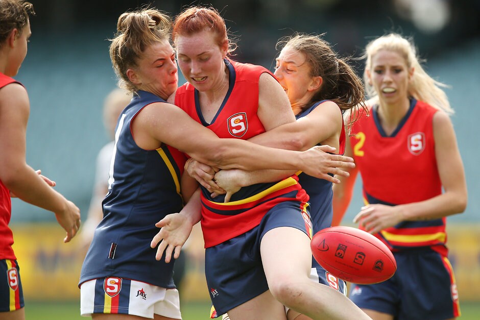 AFL 2016 Media - SANFL All Stars Womens Match MELBOURNE, AUSTRALIA - APRIL 2: Ebony Marino and Alli Evans of SA Blue tackle Nicolle Mark of SA Red during the SANFL All Stars Womens match at Adelaide Oval in Adelaide, Australia on April 2, 2016. (Photo by James Elsby/AFL Media)